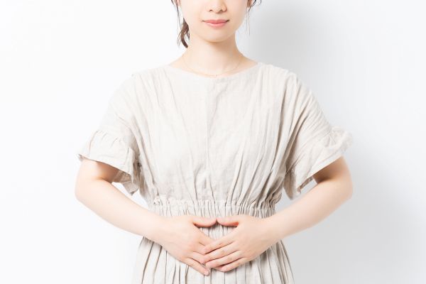 お腹に不調を感じている女性